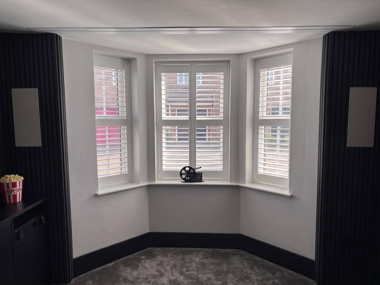 Bay window with ceiling recessed screen hidden