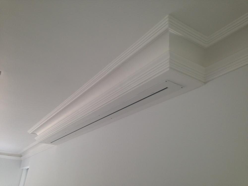 Motorised projector screen hidden in coving